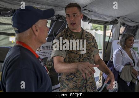U.S. Navy Petty Officer 1st Class Robert Delange, a corpsman with 1st Medical Battalion, 1st Marine Logistics Group, explains the functions and responsibilities of a shock trauma platoon during Los Angeles Fleet Week, Sept. 1, 2018. Los Angeles Fleet Week provides an opportunity for the Marine Corps and Navy to demonstrate the quality of personnel to the citizens of Los Angeles and surrounding areas. Static displays give the Marine Corps the opportunity to cultivate the Navy-Marine Corps relationship with the American people and to showcase the ability to serve as an expeditionary force in rea Stock Photo