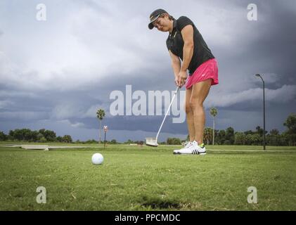 Army Reserve Lt. Col. Sunny K. Mitchell, commander, 3rd Battalion, Special Operations Command, Army Reserve Element, 76th Operational Response Command practices her putting game at the golf course on MacDill Airforce Base, Tampa, Florida, August 29. Mitchell has competed on the All-Army Golf Team for 14 years, winning her division seven times. Stock Photo