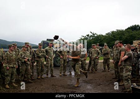 Soldiers of the Indiana National Guard’s  76th Infantry Brigade Combat Team make their own version of Highland Games. In hopes of boosting morale before the impending typhoon Jebi during Orient Shield 2018. Orient Shield underscores the strength of the close, long - standing relationship the United States has with Japan and the Japan Self Defense Force. The exercise demonstrates our continuing commitment to deepen our strong ties of mutual respect and friendship. Stock Photo