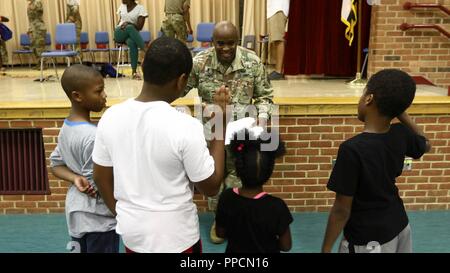 Lt. Col. Terrell Jones, command chaplain for the 20th CBRNE Command, gives the ‘Oath to Be a Good Student’ to students of Edgewood Elementary School in Edgewood, Md., at their Back-to-School night Aug. 30. Jones was one of several Soldiers from the 20th who participated in welcoming students as they start the new school year. Stock Photo