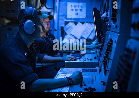 SEA (Sept. 4, 2018) Sonar Technician (Surface) 2nd Class Jacob Ferrantino stands watch in the sonar control room aboard the Arleigh Burke-class guided-missile destroyer USS Carney (DDG 64), Sept. 4, 2018. Carney, forward-deployed to Rota, Spain, is on its fifth patrol in the U.S. 6th Fleet area of operations in support of regional allies and partners as well as U.S. national security interests in Europe and Africa. Stock Photo