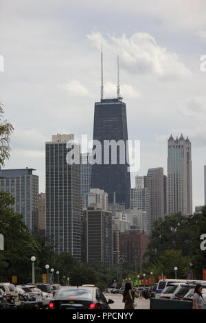 The John Hancock Center Building Tower and it's surrounding buildings as seen from the Lincoln Park Zoo as a partial Chicago skyline during the day. Stock Photo