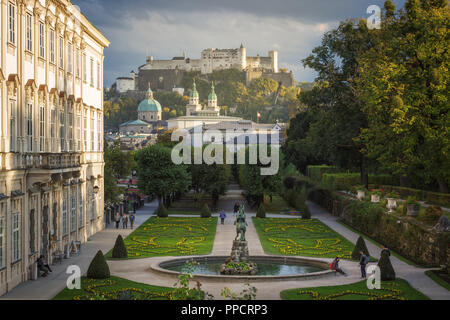 View of Mirabell Palace and gardens, and Hohensalzburg Fortress in background, Salzburg, Austria Stock Photo