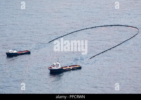 Two boats cleaning up oil spill in Gulf of Mexico, Grand Isle, Louisiana, USA Stock Photo