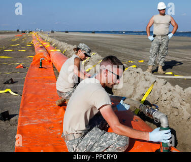 National Guard assembling containment boom to protect Grand Isle State Park beach from oil spill, Grand Isle, Louisiana, USA Stock Photo