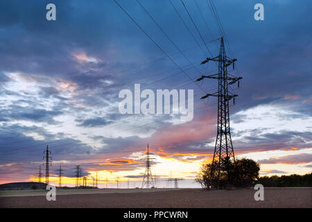 Electricity - Power energy Industry - Electric poles at the sunset with coloful sky Stock Photo