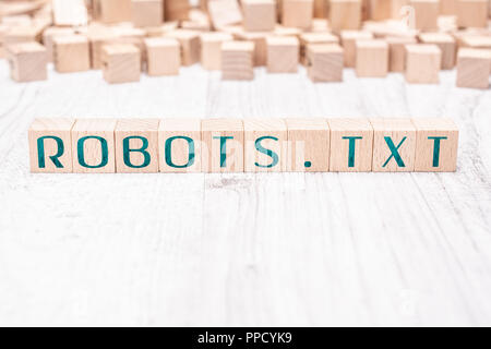 The Word Robots.txt Formed By Wooden Blocks On A White Table Stock Photo