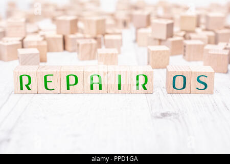 The Words Repair OS Formed By Wooden Blocks On A White Table Stock Photo