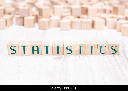 The Word Statistics Formed By Wooden Blocks On A White Table Stock Photo