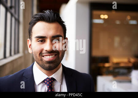 Young Hispanic businessman smiling to camera Stock Photo