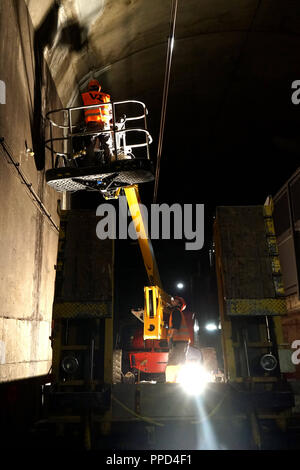 During the nighttime inspection experts of the Munich S-Bahn tunnel look for attrition and damage and mend broken bodies. The photo shows an employee of a construction company repairing a damaged area in the tunnel under the Marienplatz. Stock Photo