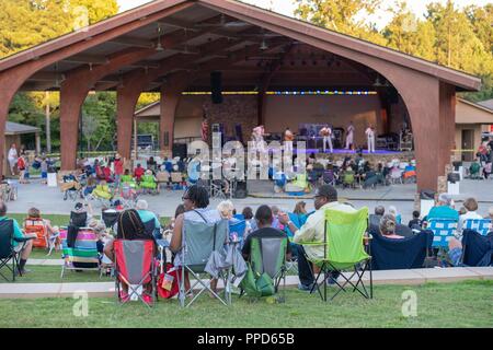JOHNS CREEK, Ga. (Aug. 31, 2018) Audience members enjoy an outdoor performance by the U.S. Navy Band Country Current at the Mark Burkhalter Amphitheater at Newtown Park in Johns Creek, Georgia. Country Current is on a ten-day tour through Virginia, North Carolina, Georgia and Florida, entertaining audiences while connecting Americans to their Navy. Stock Photo
