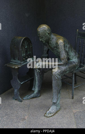 Franklin Delano Roosevelt Memorial. Bronze statue that depicts the Great Depression. Man listening to a fireside chat on the radio. Washington D.C. United States. Stock Photo