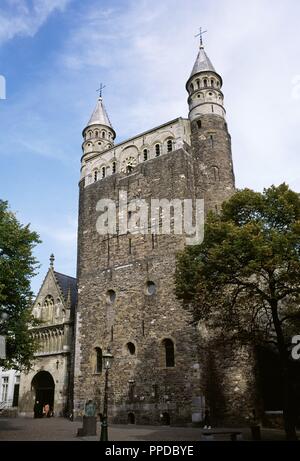 Netherlands. Maastricht. Basilica of Our Lady (Basiliek van Onze-Lieve-Vrouw). Romanesque style church. View of Entrace Merode Chapel and westwork. A 13th-century Gothic portal, rebuilt in the 15th century, provides access to the church as well as to the so-called Merode chapel (or Star of the Sea chapel). The westwork, built of carbonic sandstone, dates from the early 11th century and is flanked by two narrow towers with marlstone turrets. Stock Photo