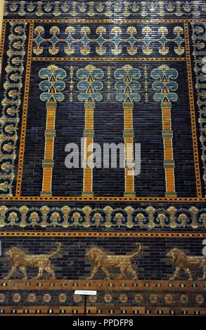 Mesopotamian art. Neo-Babylonian. The Throne Room of  Nebuchadnezzar II. Reconstructed facade. Dated in 580 B.C. Its 56 meters facade was decorated with colored glazed bricks as shows the composition, including stylized palms. The frieze of lions was presumably arranged symmetrically so that the animals faced toward the central main entrance to the trone-room. Pergamon Museum. Berlin. Germany. Stock Photo