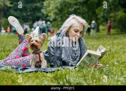 a Portrait of a young woman with a little dog Stock Photo