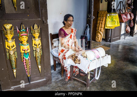 Galle, Sri Lanka - August, 8, 2017: A woman demonstrating the intricate art of making pillow lace or bobbin lace in Galle  Sri Lanka. Stock Photo