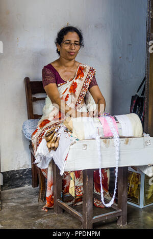 Galle, Sri Lanka - August, 8, 2017: A woman demonstrating the intricate art of making pillow lace or bobbin lace in Galle  Sri Lanka. Stock Photo
