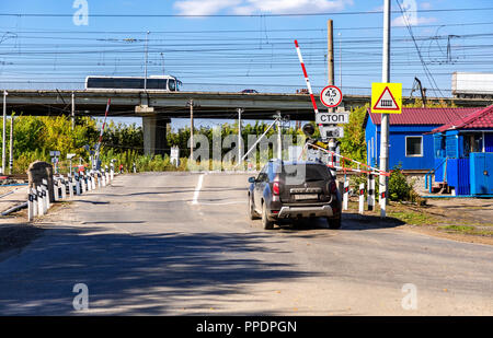 Samara, Russia - September 23, 2018: Traffic light and road sign on the railway crossing Stock Photo