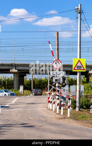 Samara, Russia - September 23, 2018: Traffic light and road sign on the railway crossing Stock Photo