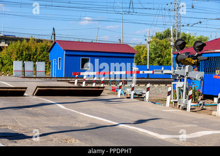 Samara, Russia - September 23, 2018: Traffic light and road sign on the railway crossing Stock Photo