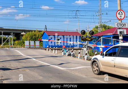 Samara, Russia - September 23, 2018: Traffic light and road sign on the railway crossing Stock Photo