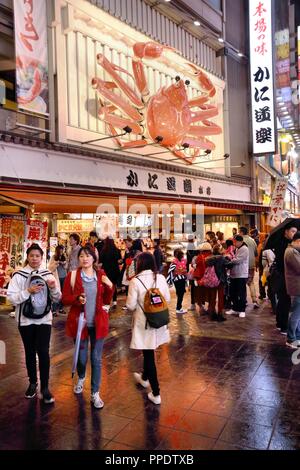 OSAKA, JAPAN - NOVEMBER 21, 2016: People visit Dotonbori street in Osaka, Japan. Dotonbori is the main entertainment area of Osaka. Stock Photo