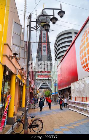 OSAKA, JAPAN - NOVEMBER 23, 2016: People walk in Shinsekai neighborhood of Osaka, Japan. Osaka belongs to 2nd largest metropolitan area of Japan (19.3 Stock Photo