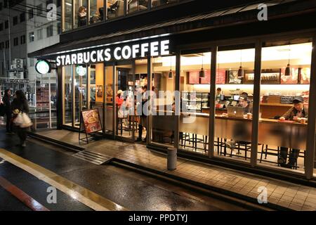 KYOTO, JAPAN - NOVEMBER 27, 2016: People visit Starbucks Coffee cafe in Kyoto, Japan. Starbucks has 28,200 locations around the world. Stock Photo