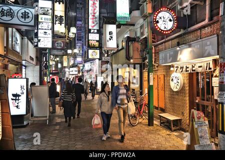 OSAKA, JAPAN - NOVEMBER 22, 2016: People visit restaurants along shopping street in Umeda district, Osaka. Osaka belongs to 2nd largest metropolitan a Stock Photo