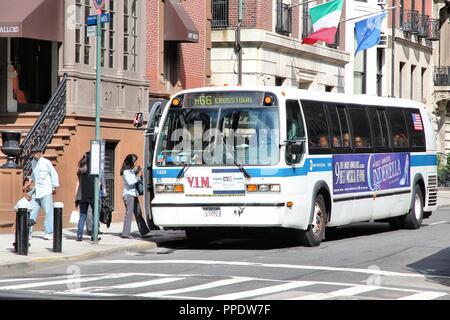 NEW YORK, USA - JULY 2, 2013: People board MTA bus in New York. MTA carries over 11 million passengers on a typical weekday systemwide. Stock Photo