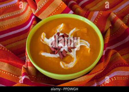 Homemade autumn pumpkin creamy soup on wooden table Stock Photo