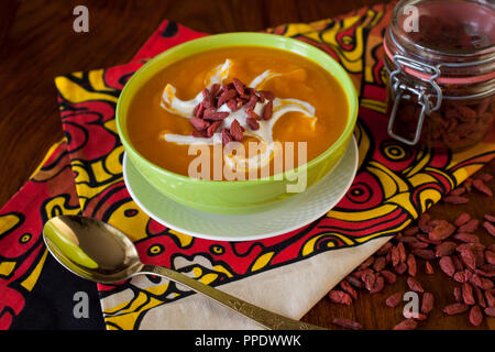 Homemade autumn pumpkin creamy soup on wooden table Stock Photo