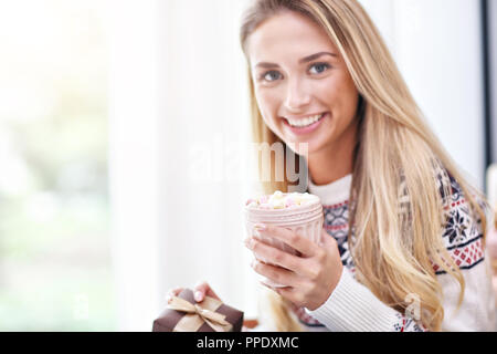 Adult woman relaxing at home during Christmas time Stock Photo