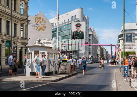Berlin, Germany - May 28, 2017: Tourists on the street near the Checkpoint Charlie in Berlin. Checkpoint Charlie famous passage between the West and E Stock Photo