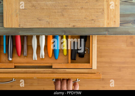 Fitted knife drawer in a wooden kitchen cabinet with a neat array of knives  with assorted cooking utensils in a full frame overhead view Stock Photo -  Alamy