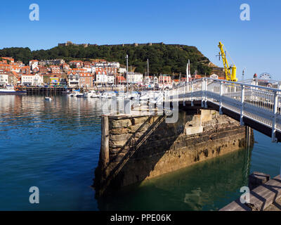 Footbridge at Vincents Pier in the harbour with Sandside and Castle Hill behind Scarborough North Yorkshire England Stock Photo