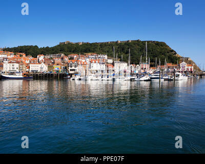Boats at the harbour and Sandside seafront buildings below Castle Hill at Scarborough North Yorkshire England Stock Photo