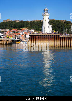 The lighthouse and seafront below Castle Hill at Scarborough North Yorkshire England Stock Photo