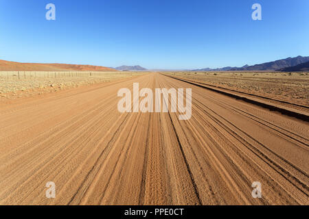 Empty road through desert, african wilderness Stock Photo