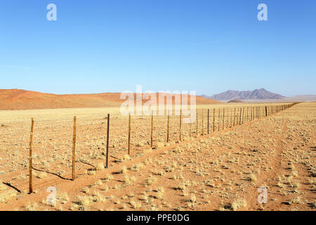 Iron fence of an rural african ranch in desert landscape Stock Photo