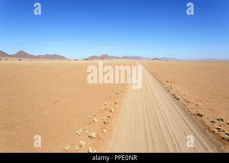 Empty road through desert, african wilderness Stock Photo