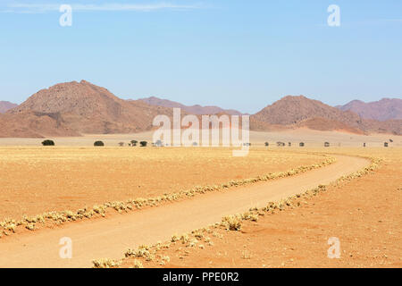 Empty road through desert, african wilderness Stock Photo