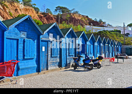 Olhus d'Agua is located on the Algarve coast of southern Portugal. The beach is still also used for fishing and here is a row of fishermen's huts. Stock Photo