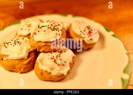 Homemade, home baked and hand decorated holiday Christmas iced pumpkin cookies with sprinkles, Wisconsin, USA Stock Photo