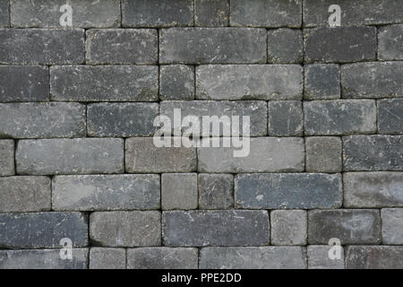 Different shades of grey bricks making up a wall. Stock Photo