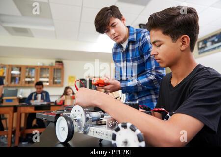 Two Male Pupils Building Robotic Vehicle In Science Lesson Stock Photo