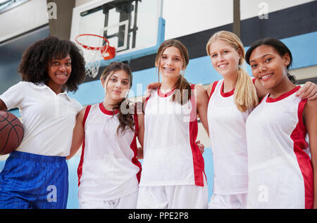 Portrait Of High School Basketball Coach With Female Team Stock Photo