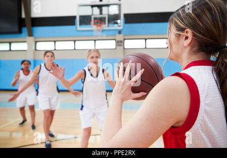 Female High School Basketball Team Passing Ball On Court Stock Photo