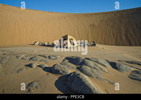 Camping in the desert, in the shelter of a hug sand dune, Namibia Stock Photo